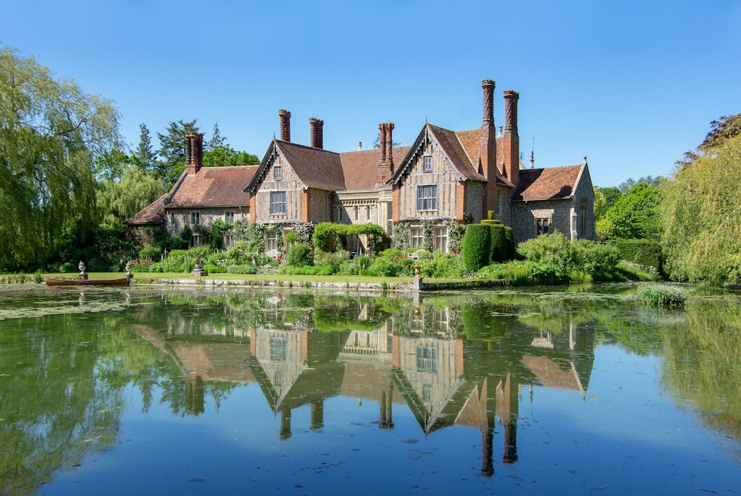 Grand English country manor house surrounded by manicured gardens