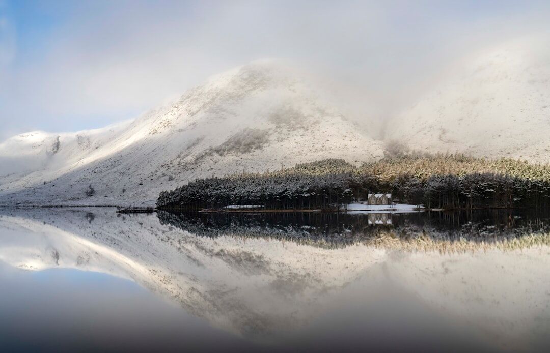 Scottish highlands loch surrounded by misty mountains