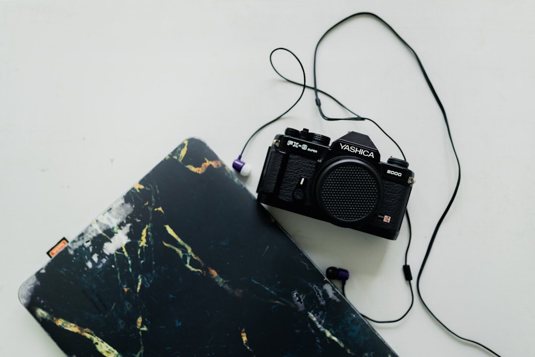 Writer's desk with laptop, camera and travel notebook