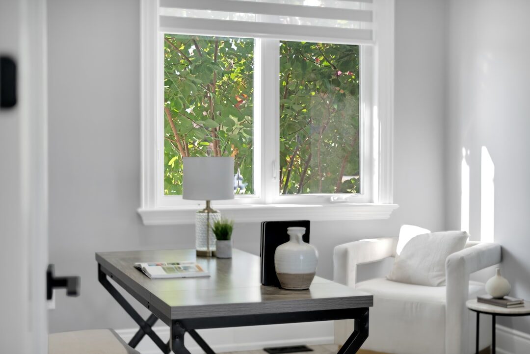 Bright editorial office with a wooden desk and large window